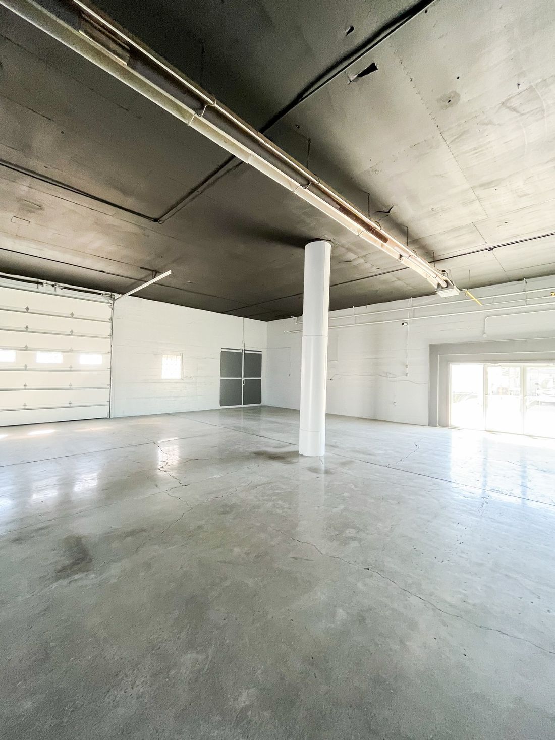 Industrial building freshly painted black and white. After photos for Moonlight Painters